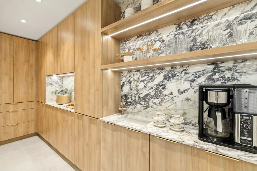 Coffee bar with floating oak shelves, LED lighting and a dramatic marble backsplash